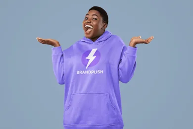 A woman in a BrandPush hoodie shrugging with open hands