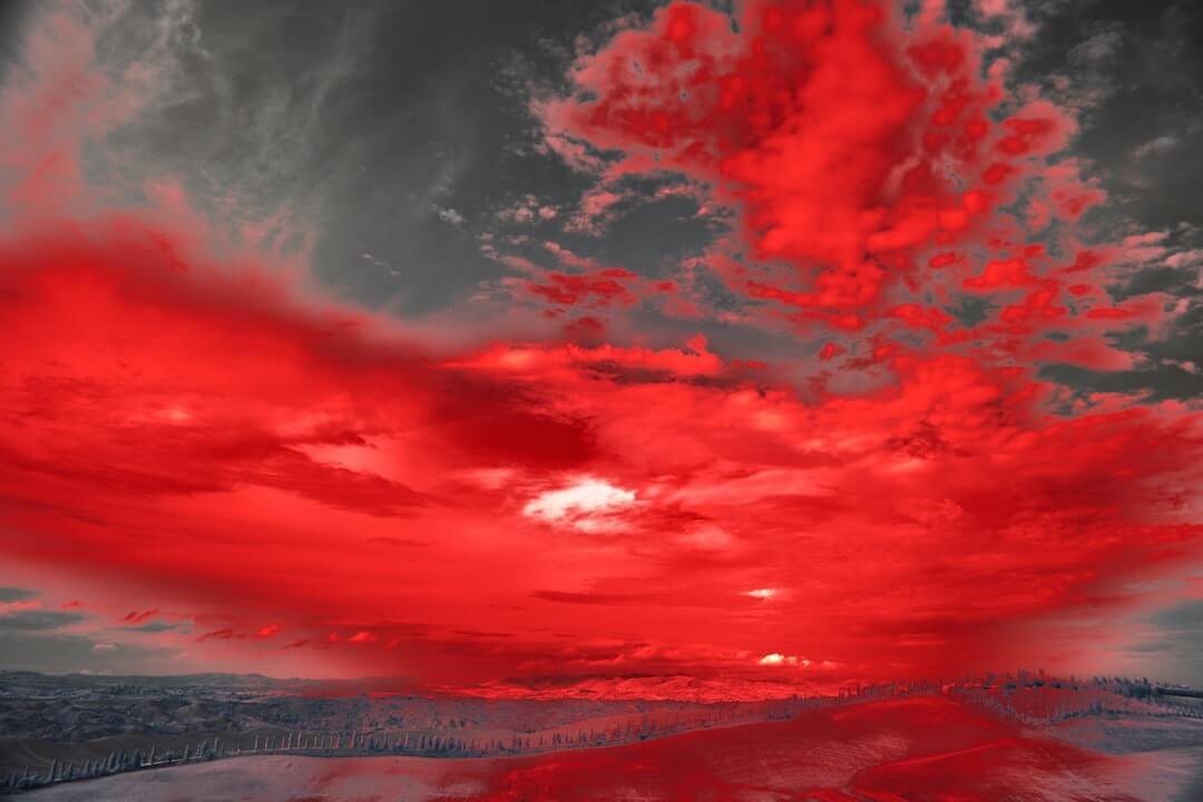 Red figure blurred in motion against white.