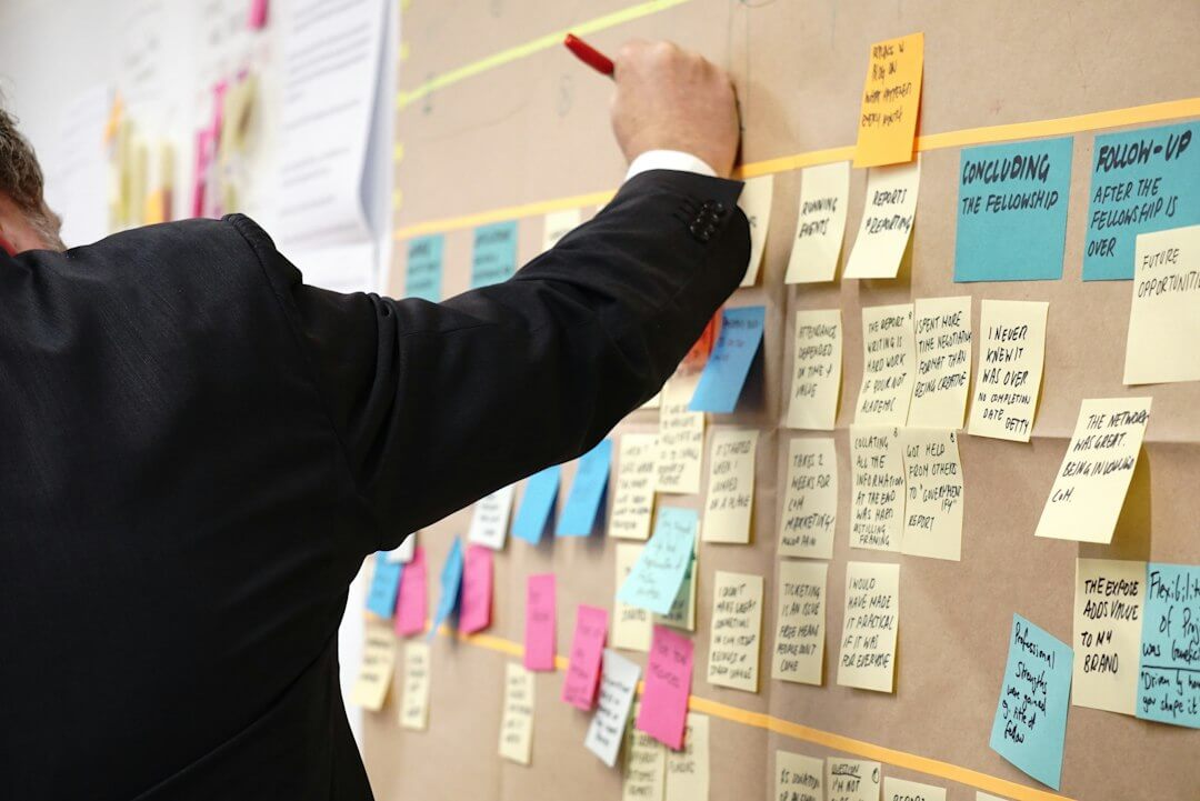 man writing on white board