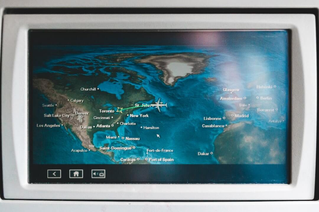 a woman pointing to a poster on a wall