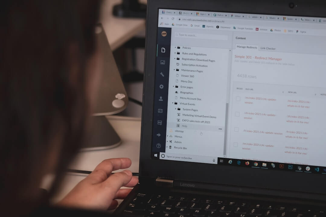 Person typing on a laptop computer screen.