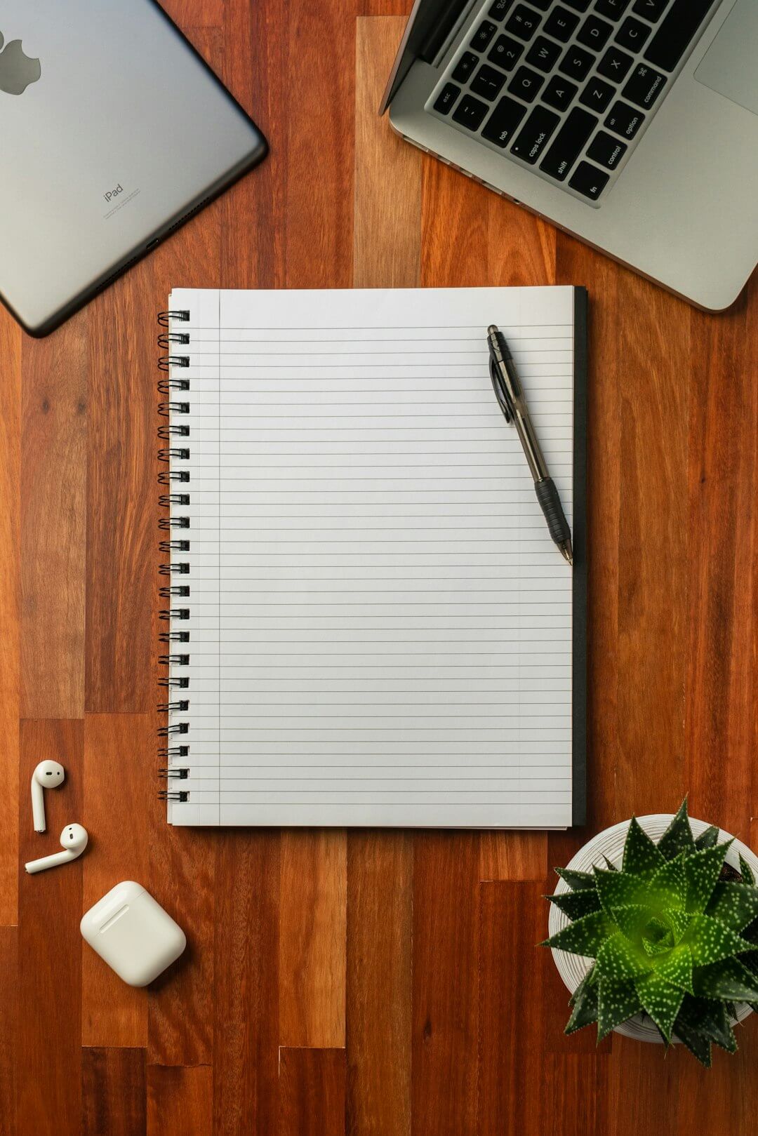 white spiral notebook on brown wooden table