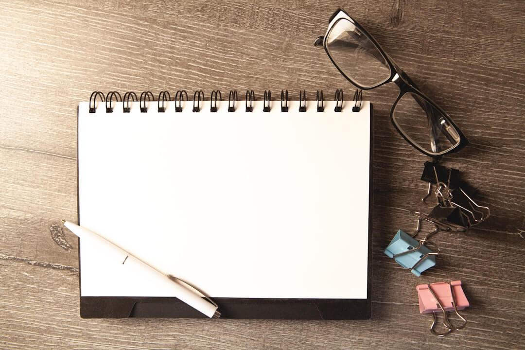 spiral notebook and black pen