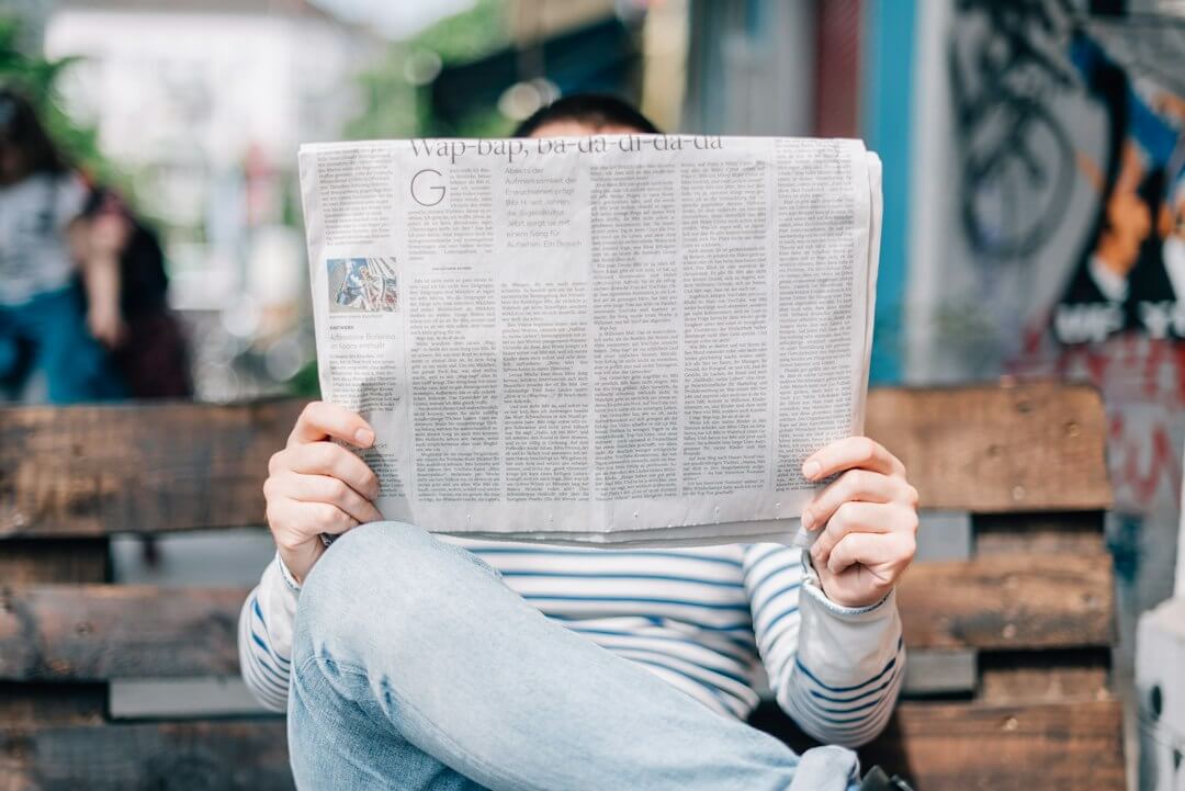 a person reading a newspaper