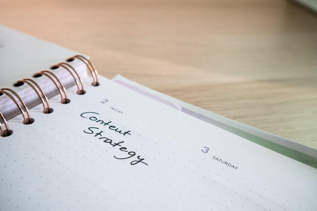 a notepad with the words marketing strategy written on it