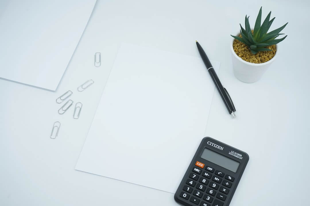 Desk with calculator, charts, and binders