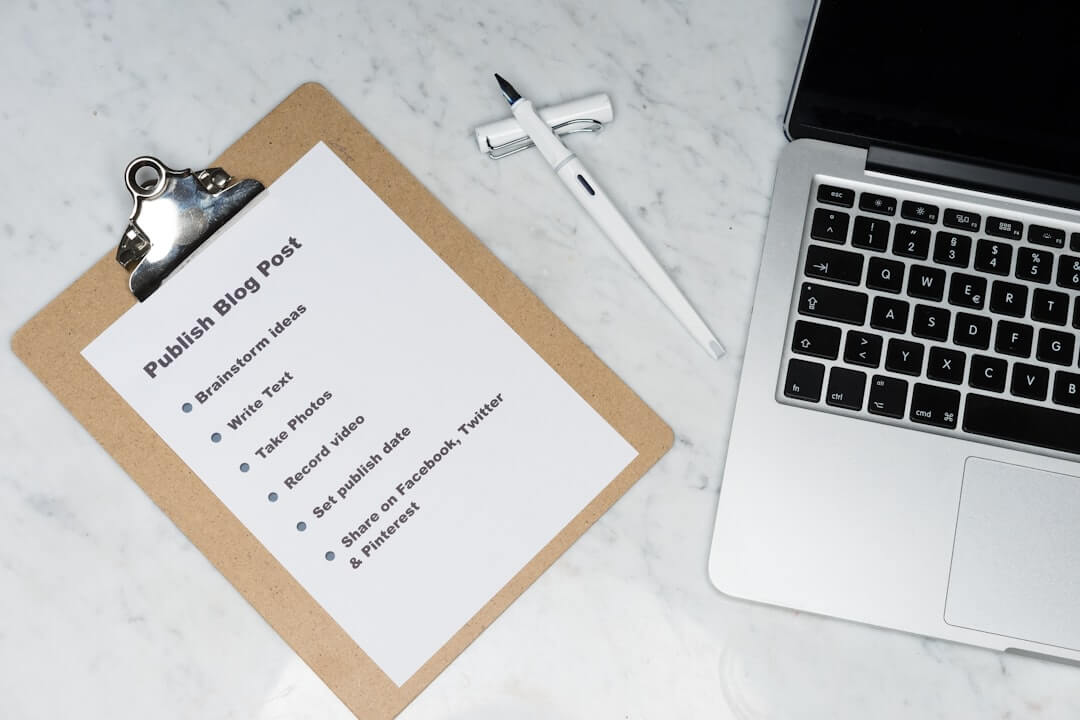 white and brown card on silver macbook