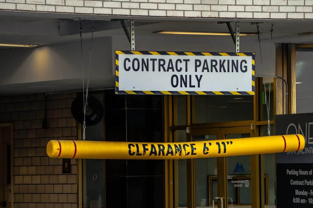 a red and white sign sitting on the side of a road