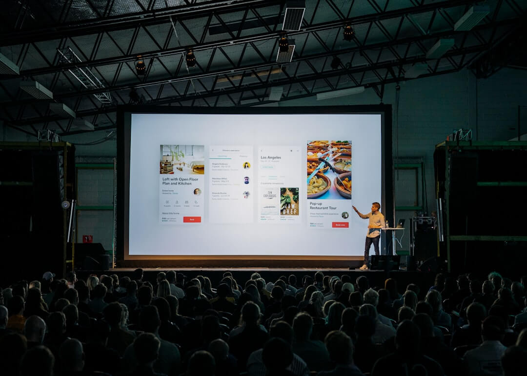 Woman presents charts on a screen to colleagues.