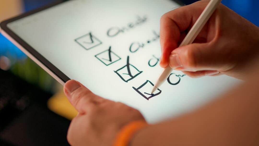 Hand checking off items on a to-do list.
