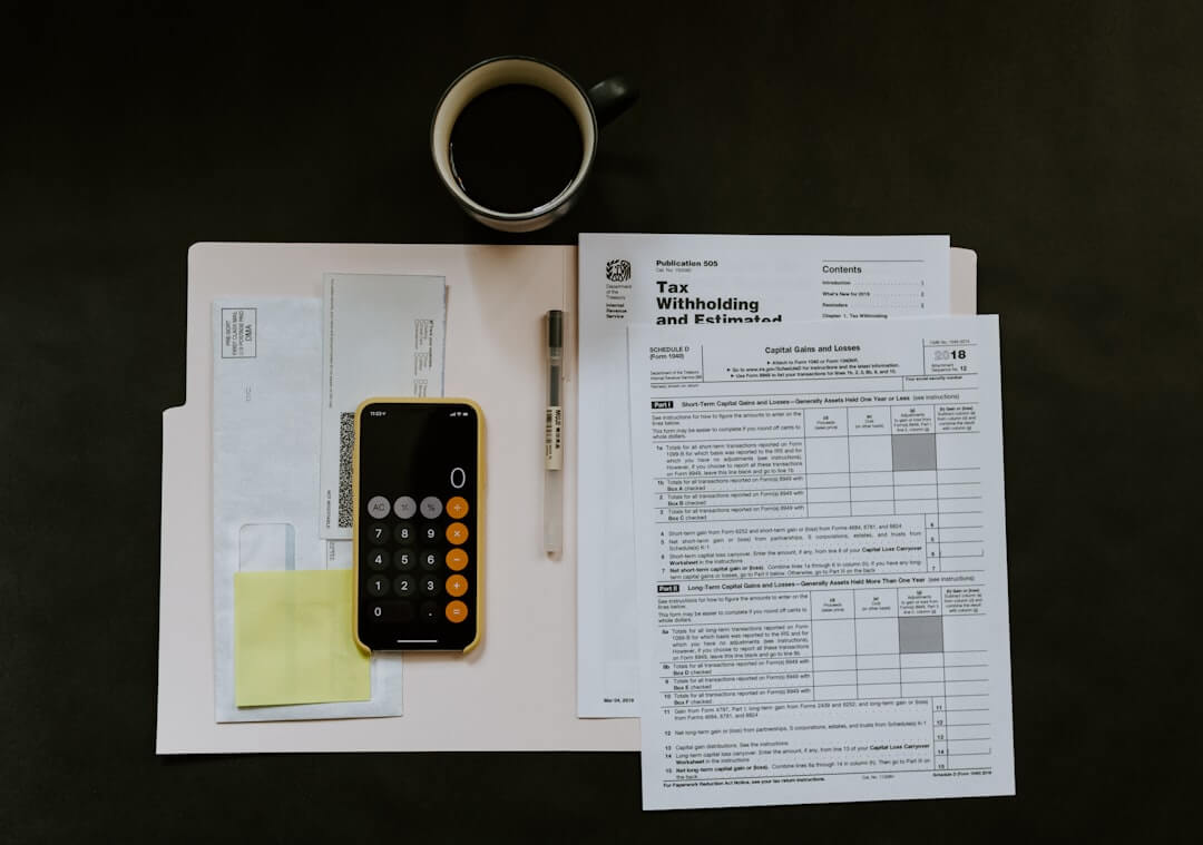 Glasses, coffee mug, and planner on a desk.