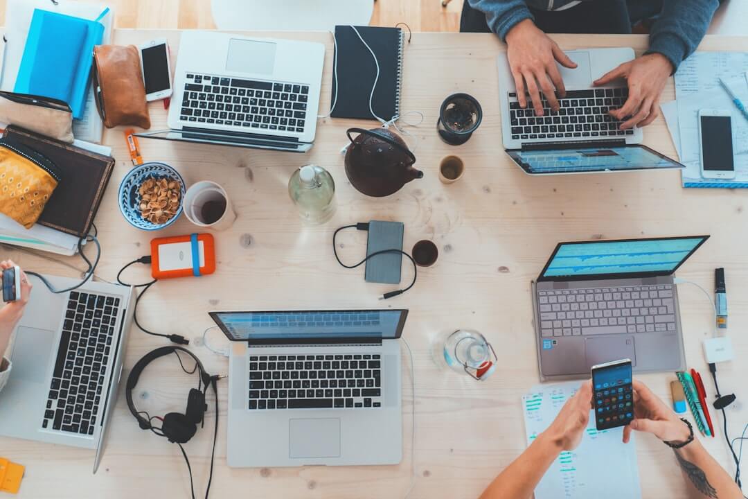 men sitting in front of their laptop computer