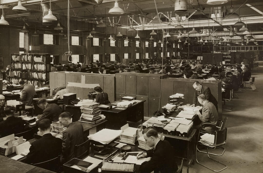 grayscale photo of man and woman sitting on chair