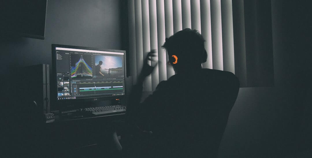 boy in black long sleeve shirt sitting on chair in front of black flat screen tv