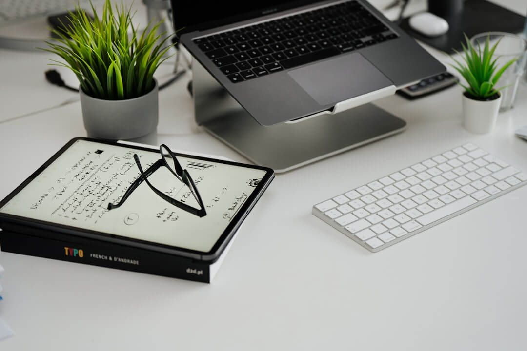 a laptop computer sitting on top of a white desk
