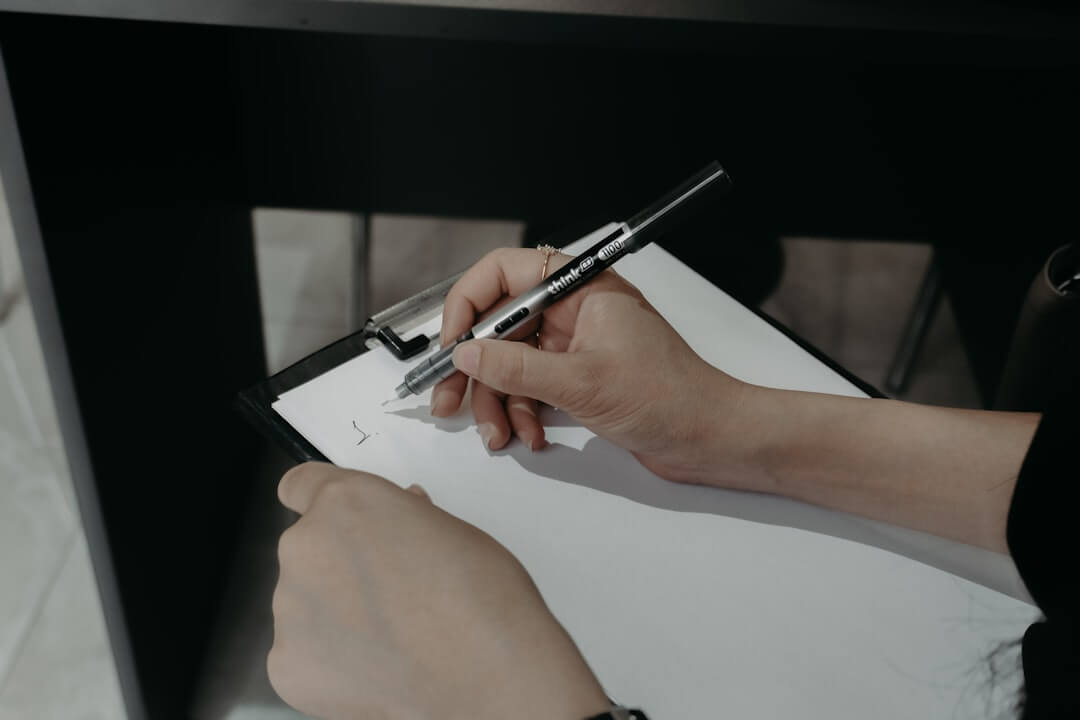 Man working at desk with laptop and notes