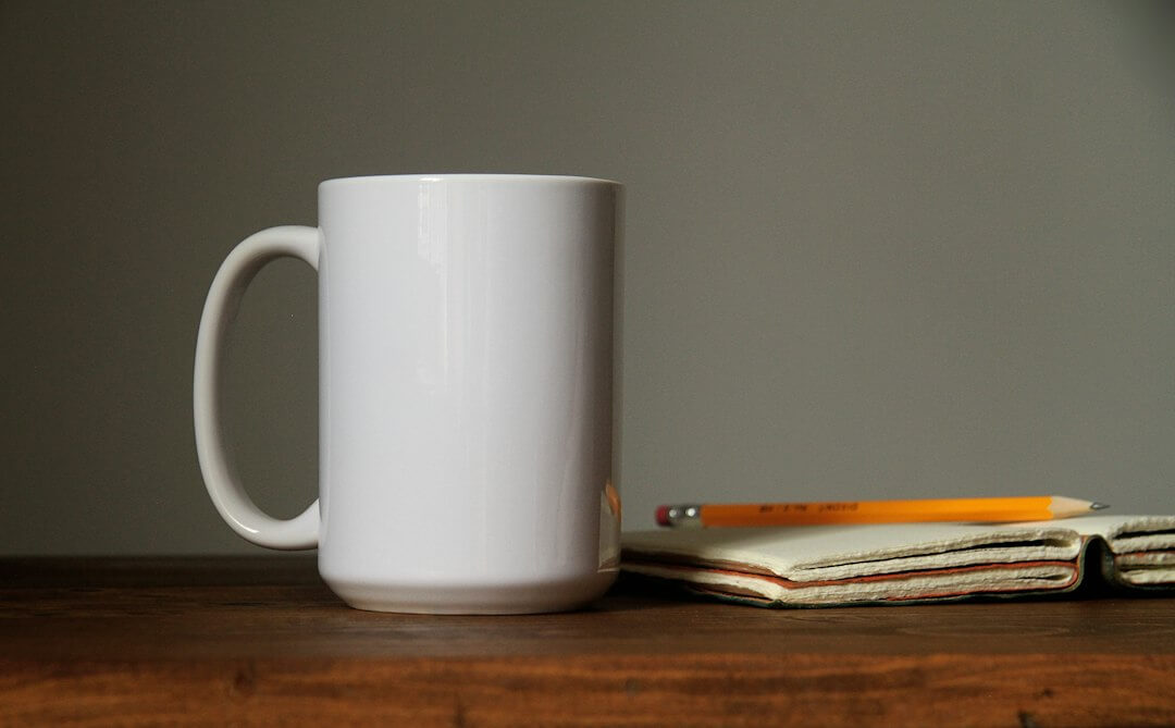 Laptop screen displaying code with a coffee mug