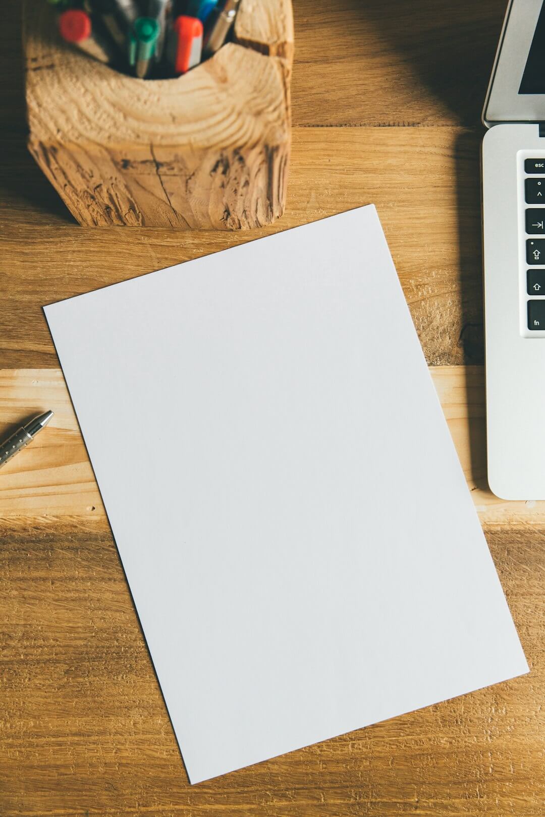 white printer paper beside white apple keyboard