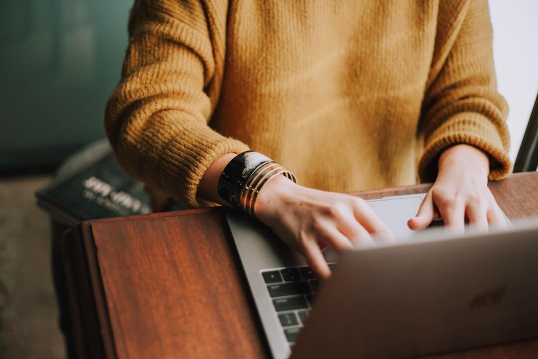 person using laptop computer beside aloe vera