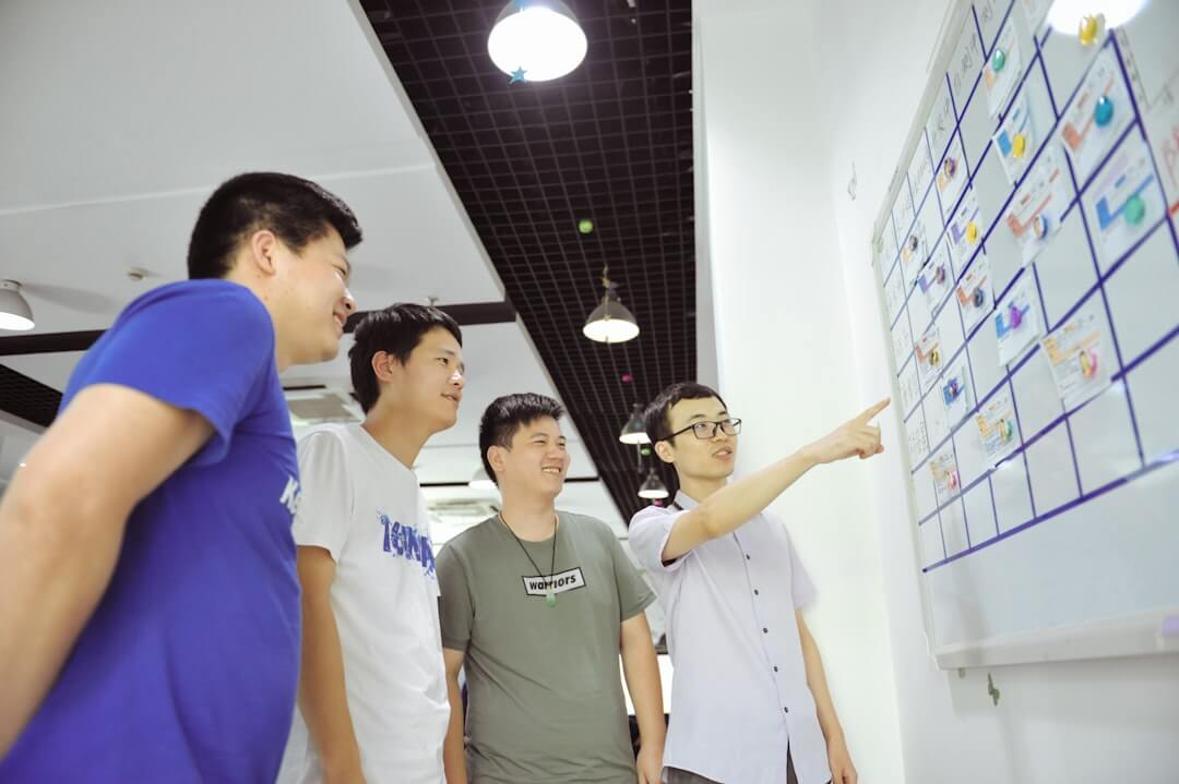 People collaborate on a project at a table.