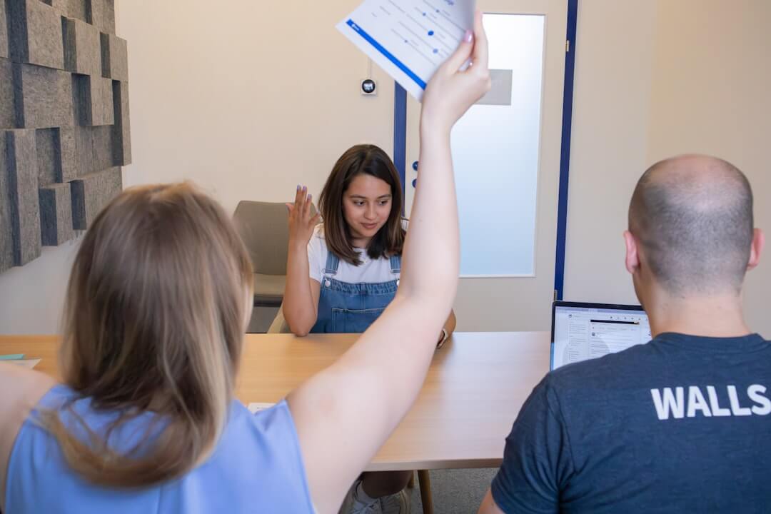 a man and a woman standing in front of a whiteboard