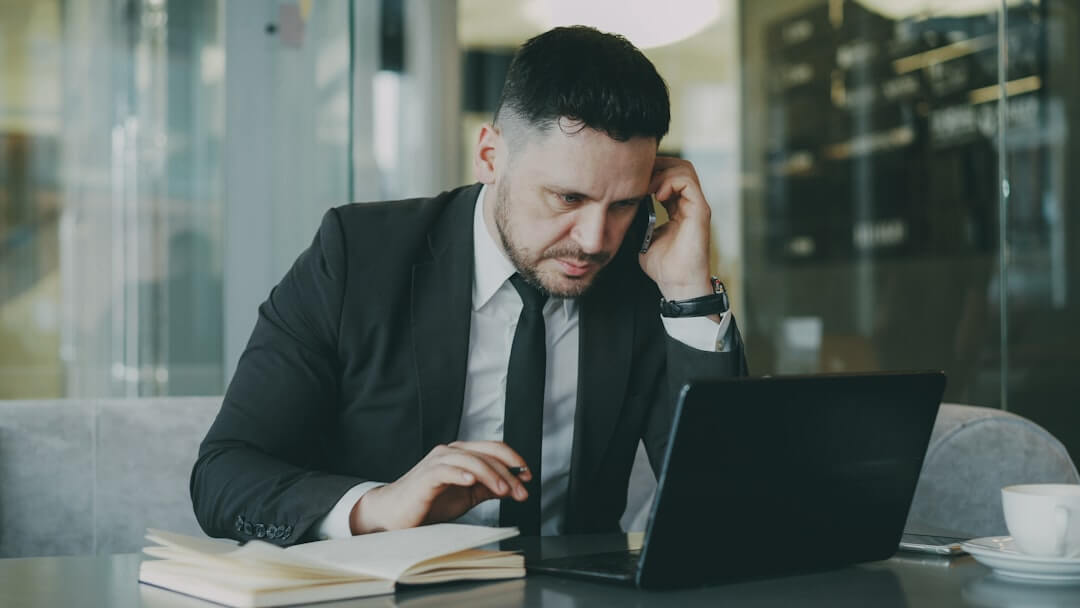 A man sitting in front of a laptop computer