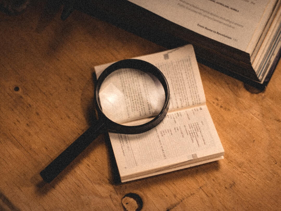 a person is writing on a paper with a pen