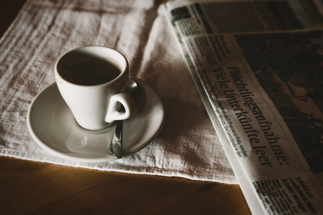 Coffee, filter, and magazine lay out on a white surface.