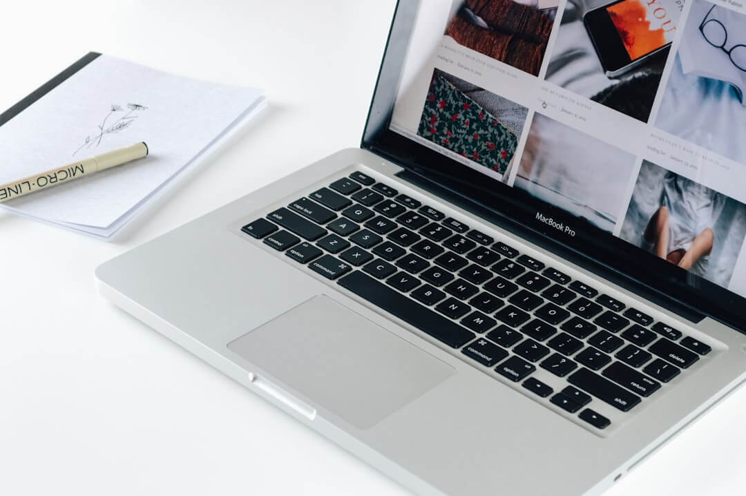 a laptop computer sitting on top of a wooden desk